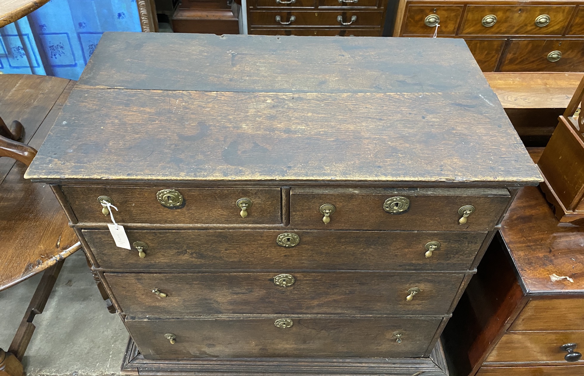 An 18th century oak chest on stand, width 102cm, depth 57cm, height 126cm